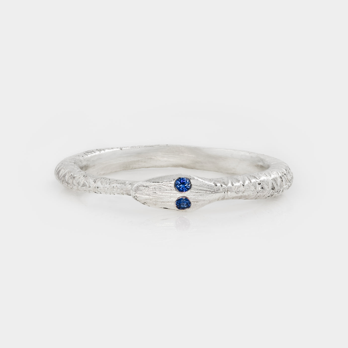 Silver ring with a blue gemstone on a white background