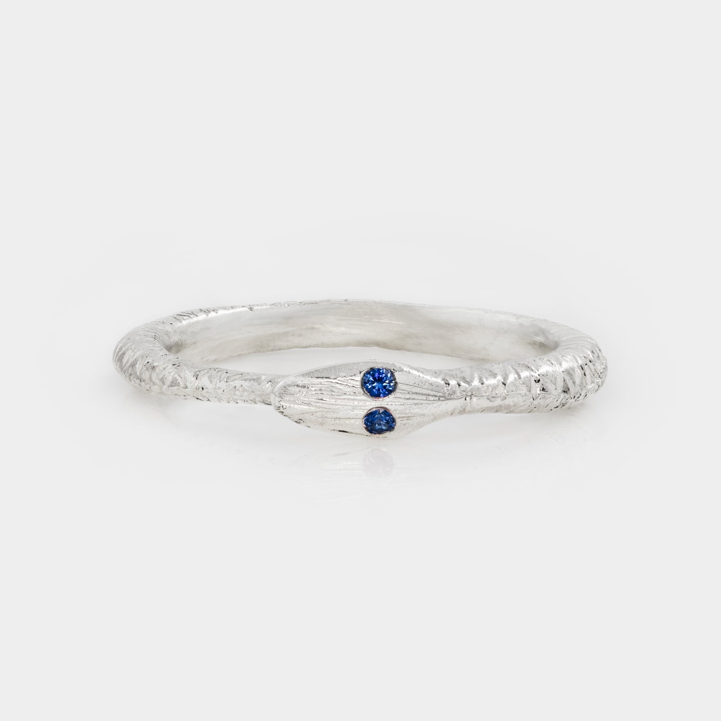 Silver ring with a blue gemstone on a white background