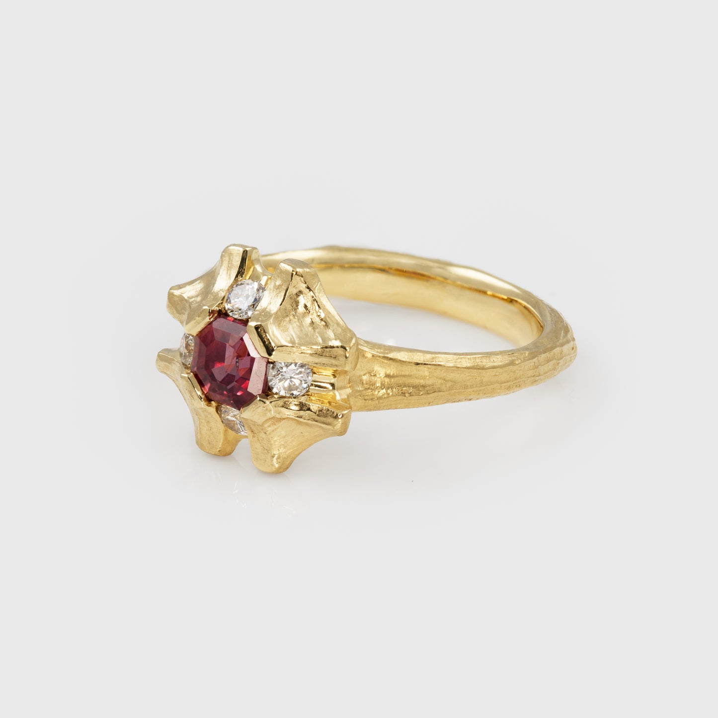 Flower shaped gold ring with pink sapphire 3/4 view