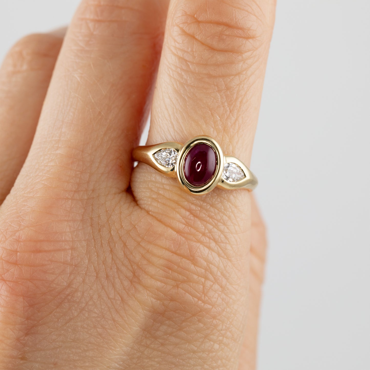 Gold ring with ruby and diamonds on hand