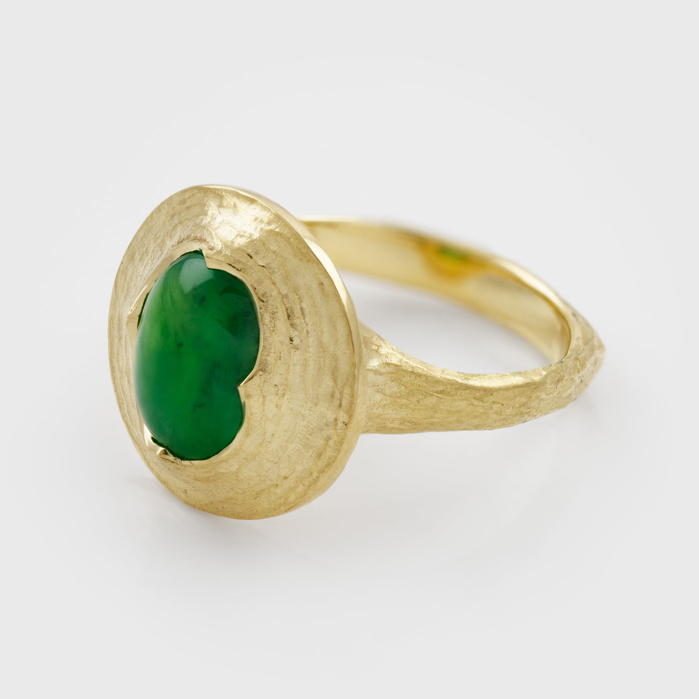 Side view of yellow gold ring featuring oval cabochon green Jade