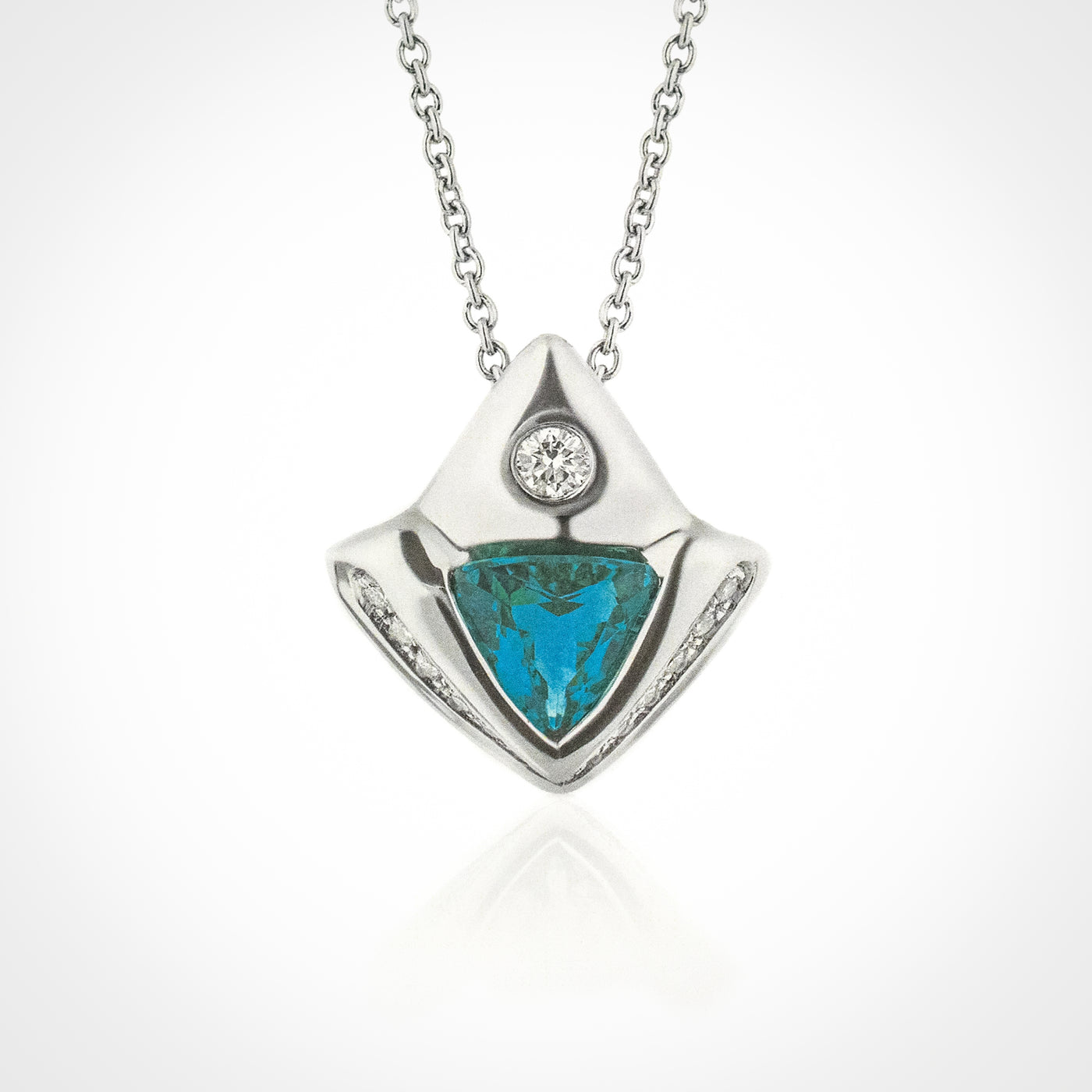 A platinum necklace with a trillion-cut Paraiba Tourmaline gemstone and diamond accents.