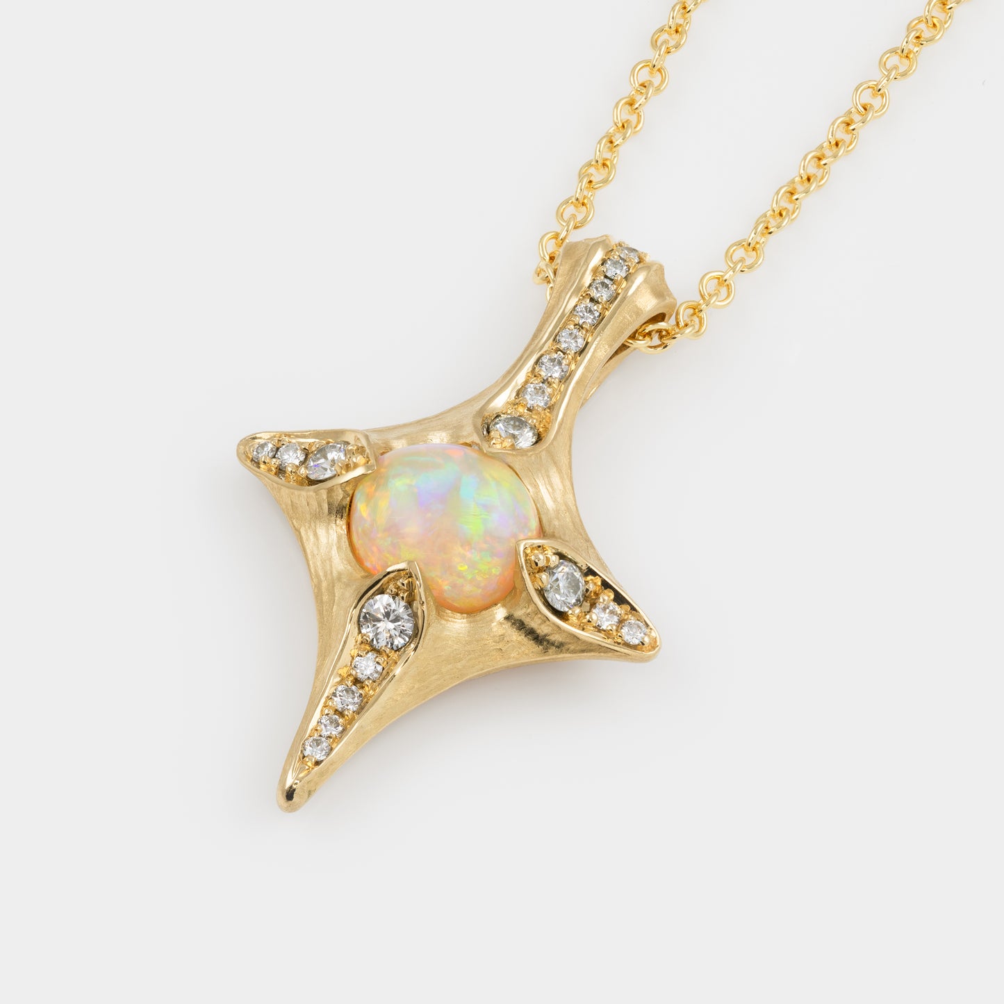 Gold pendant with opal stone and diamonds on a white background