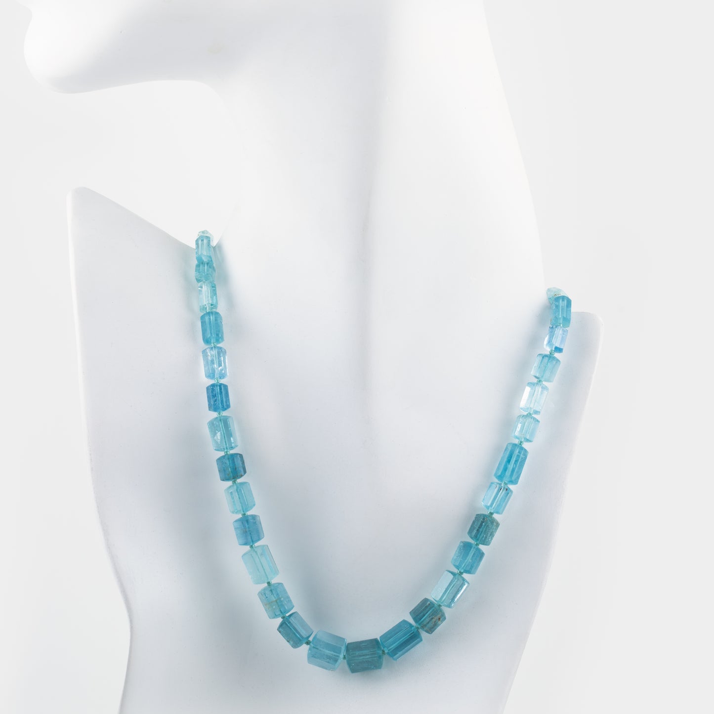 Blue beaded necklace on a white mannequin bust