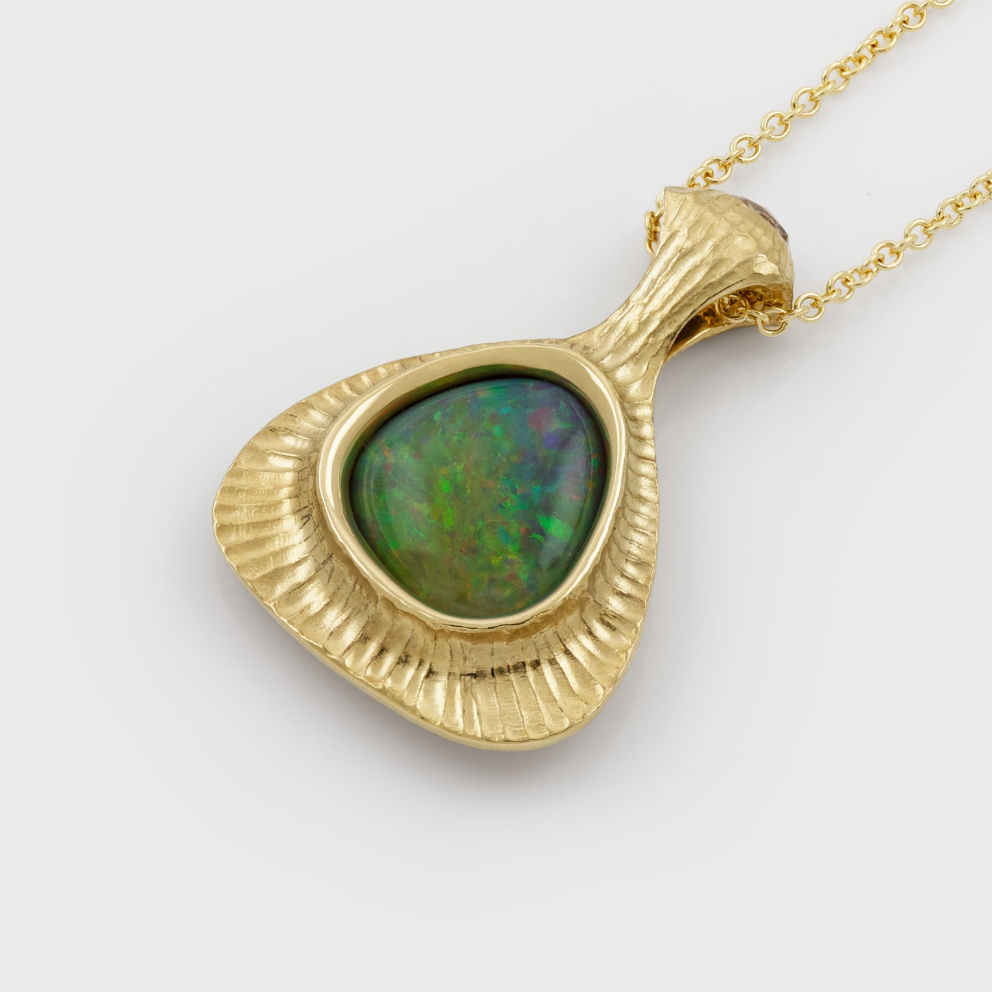 Yellow gold pendant featuring bezel set Opal
