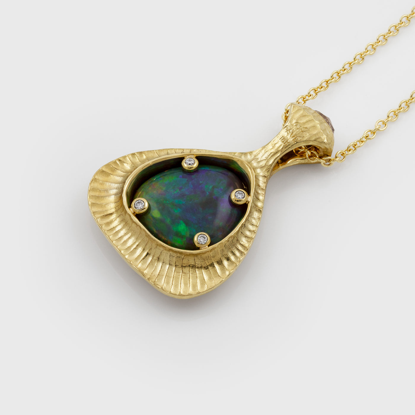 Back view of yellow gold pendant featuring bezel set Opal with 4 round Diamond accents