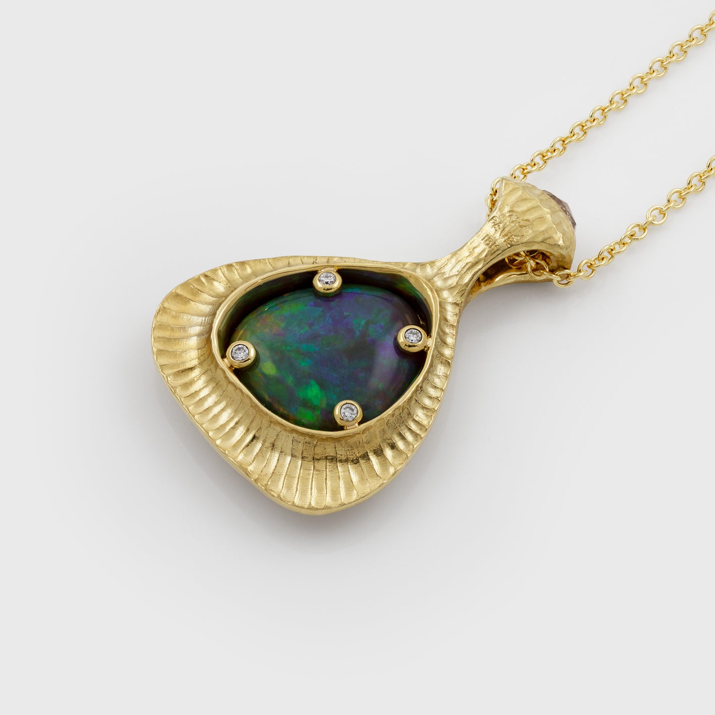 Back view of yellow gold pendant featuring bezel set Opal with 4 round Diamond accents