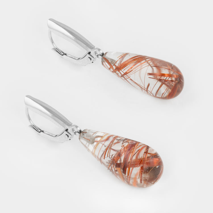 Close-up of 14k white gold drop earrings with rutilated quartz.