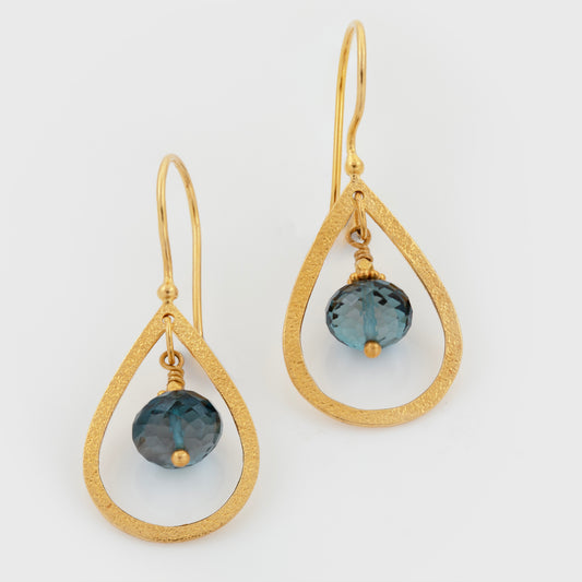 Yellow gold earrings featuring pear-shaped wire designs with London Blue Topaz drops and gold bead accents, photographed on a white background.