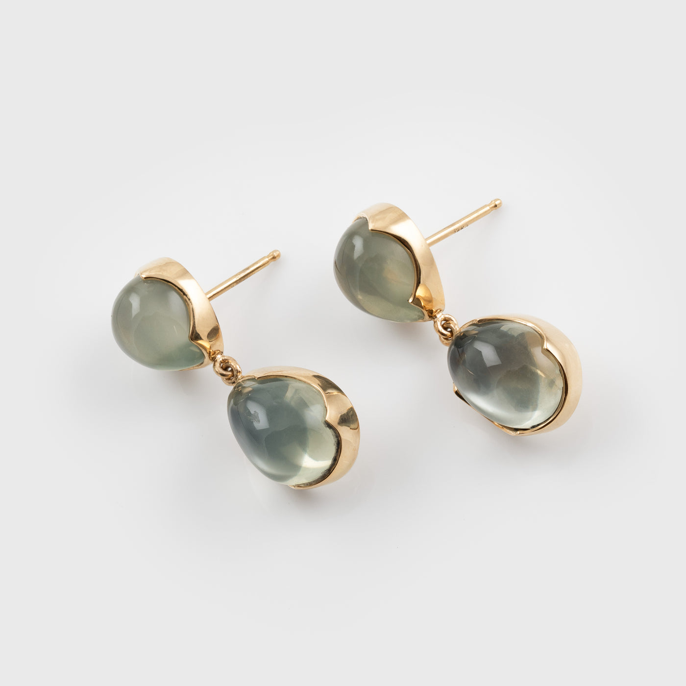 Green moonstone gemstone earrings on a white background