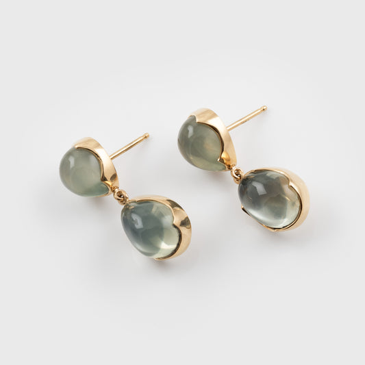 Green moonstone gemstone earrings on a white background
