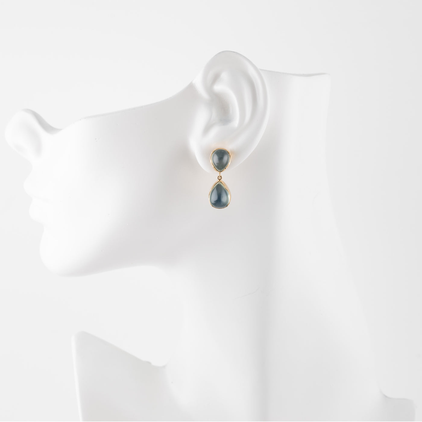 Green moonstone gemstone earrings on a white mannequin