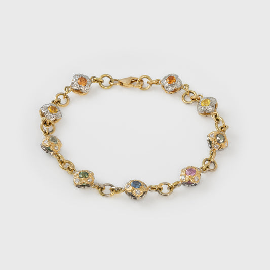 Gold bracelet with colorful gemstones on a white background