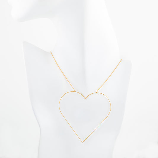 Gold heart-shaped necklace on a white background