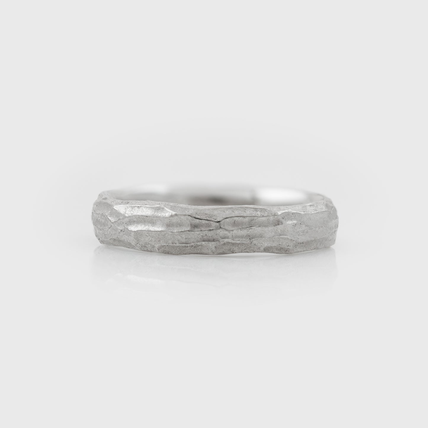 Plain platinum band with redwood bark texture on a white background front view