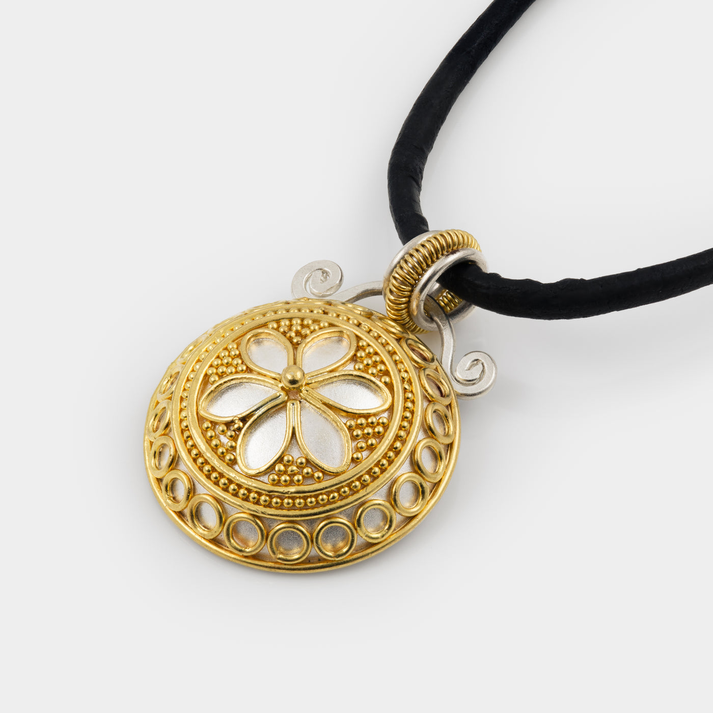 Gold and silver pendant necklace on a white background