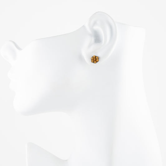 Gold earring on a white mannequin
