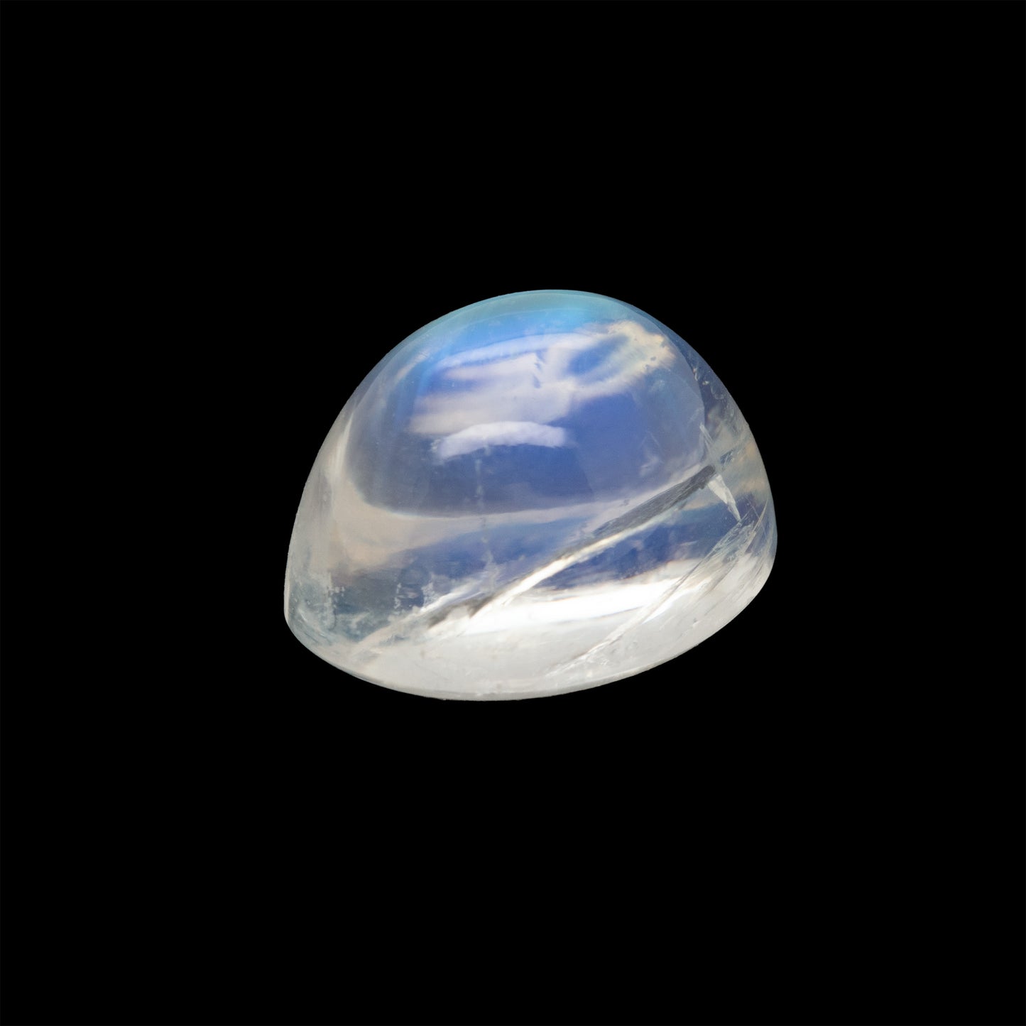 Clear moonstone gemstone with blue and white patterns on a black background