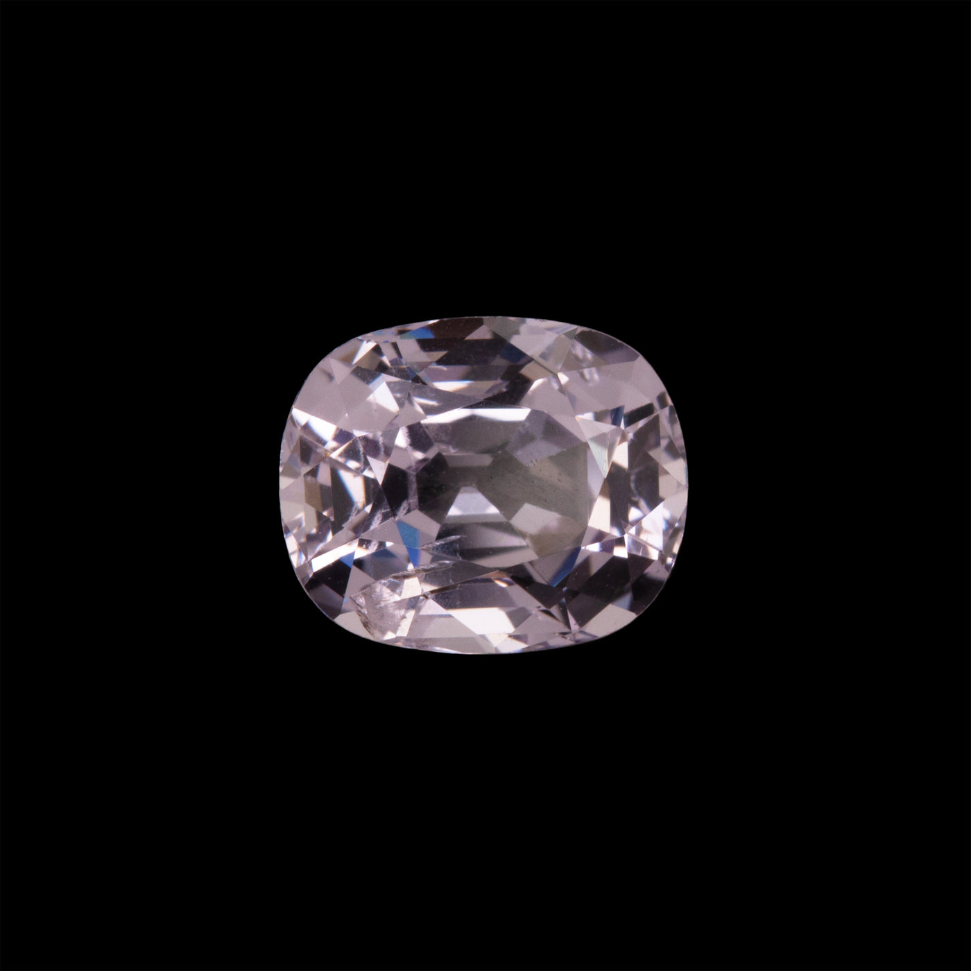 Cushion-cut pink spinel gemstone on a black background