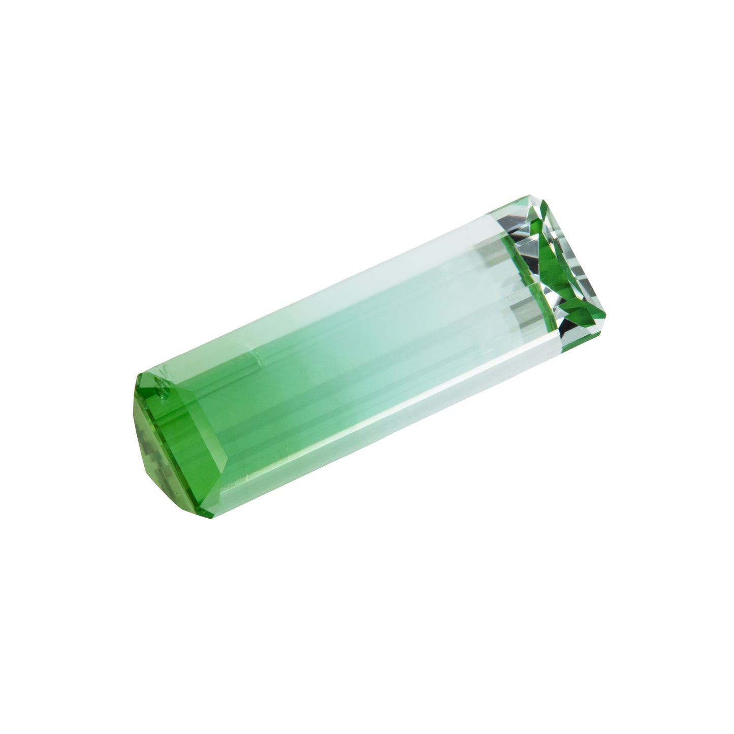 Green and blue bicolor tourmaline gemstone on a white background