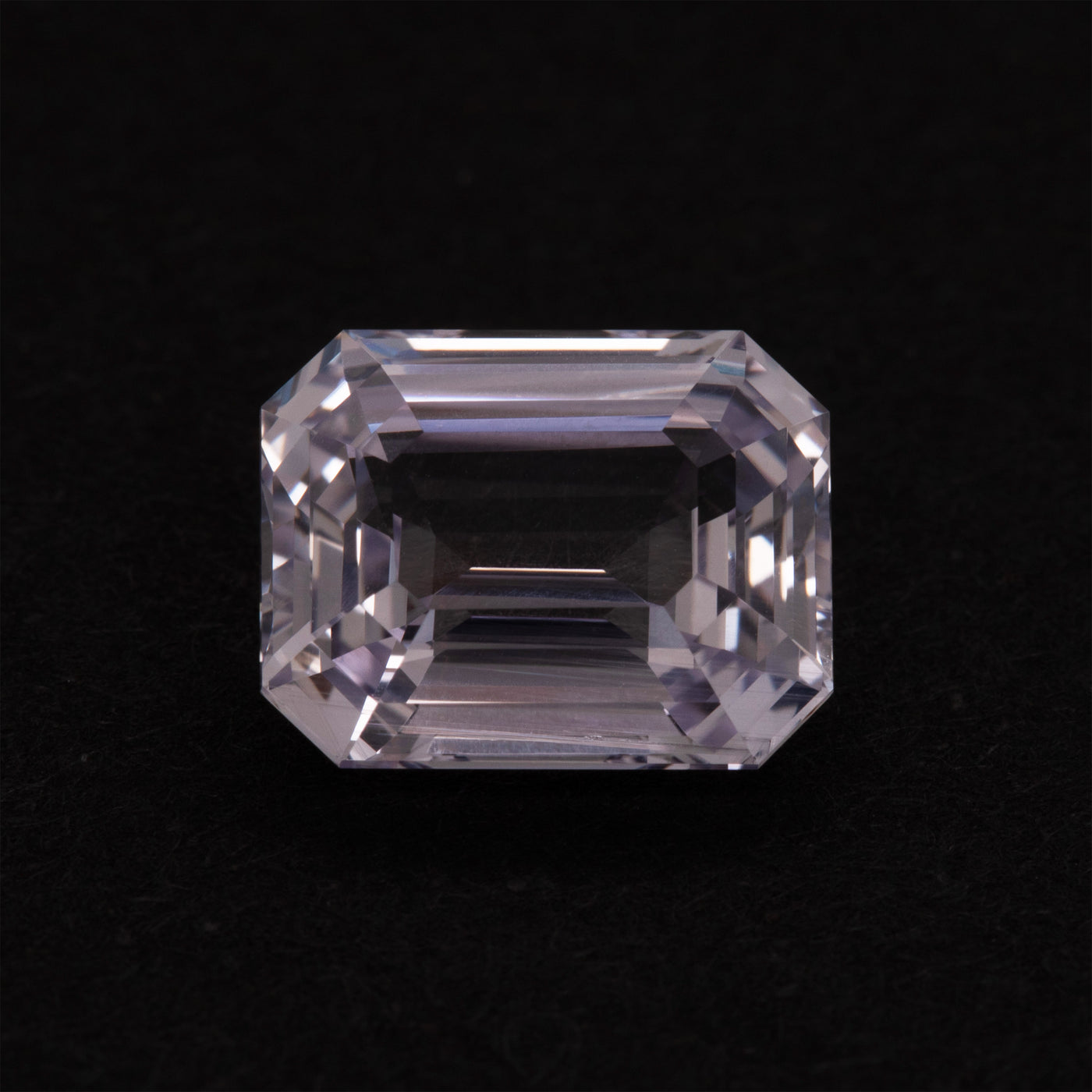 Clear violet gemstone on a black background