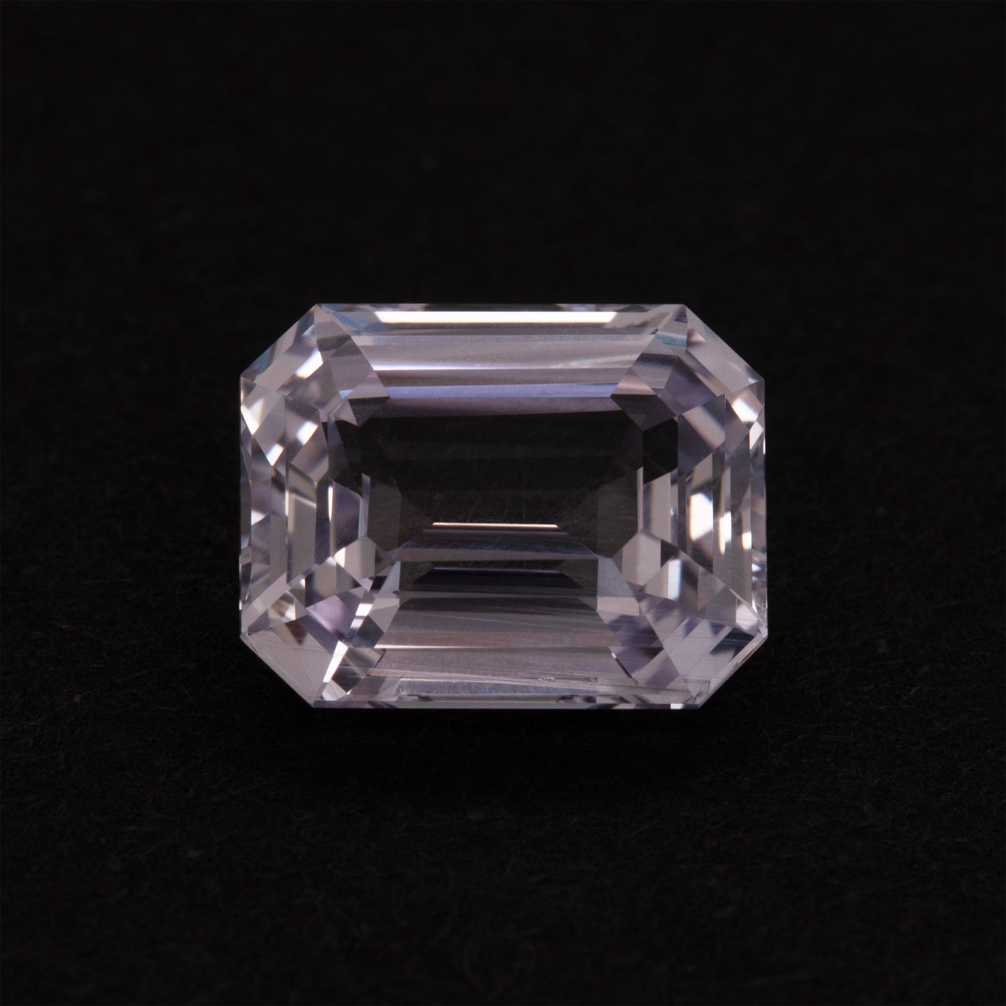 Clear violet gemstone on a black background