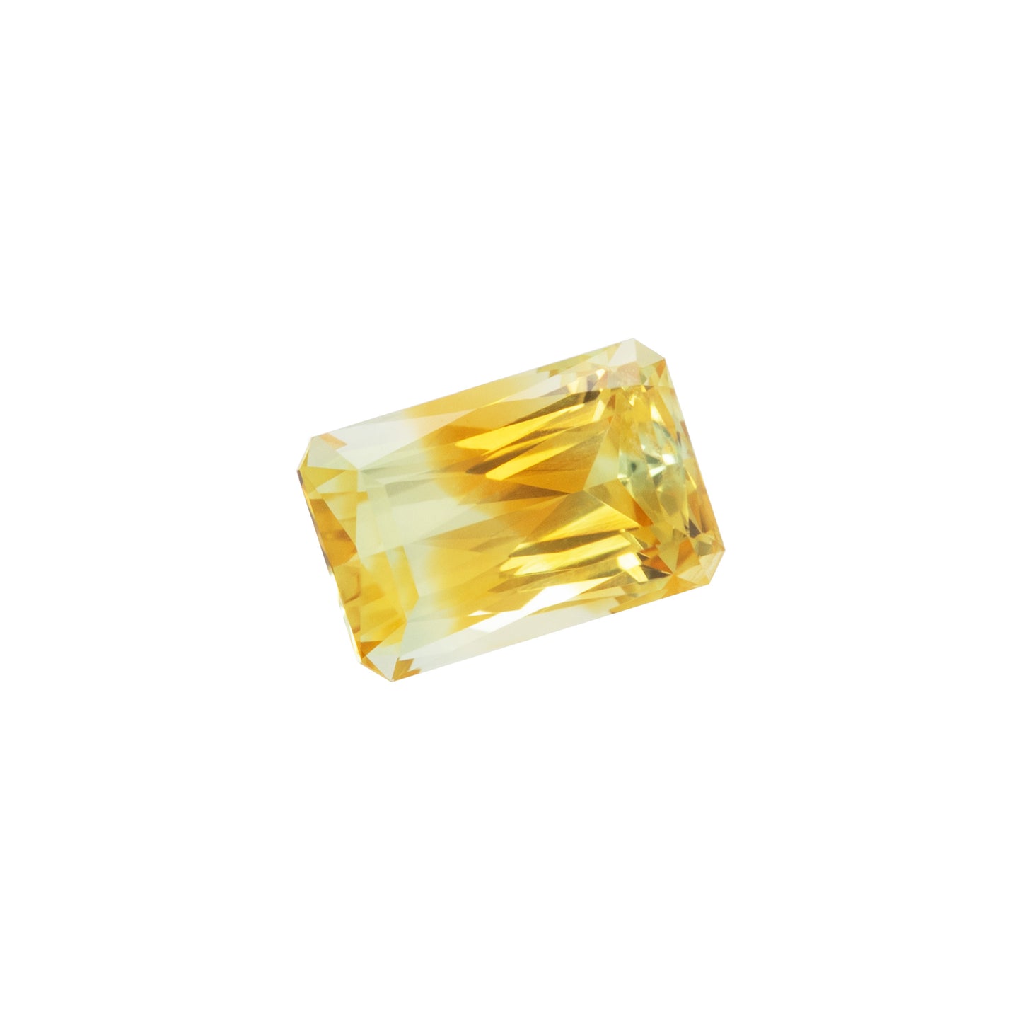 Rectangular yellow gemstone on a white background at an angle