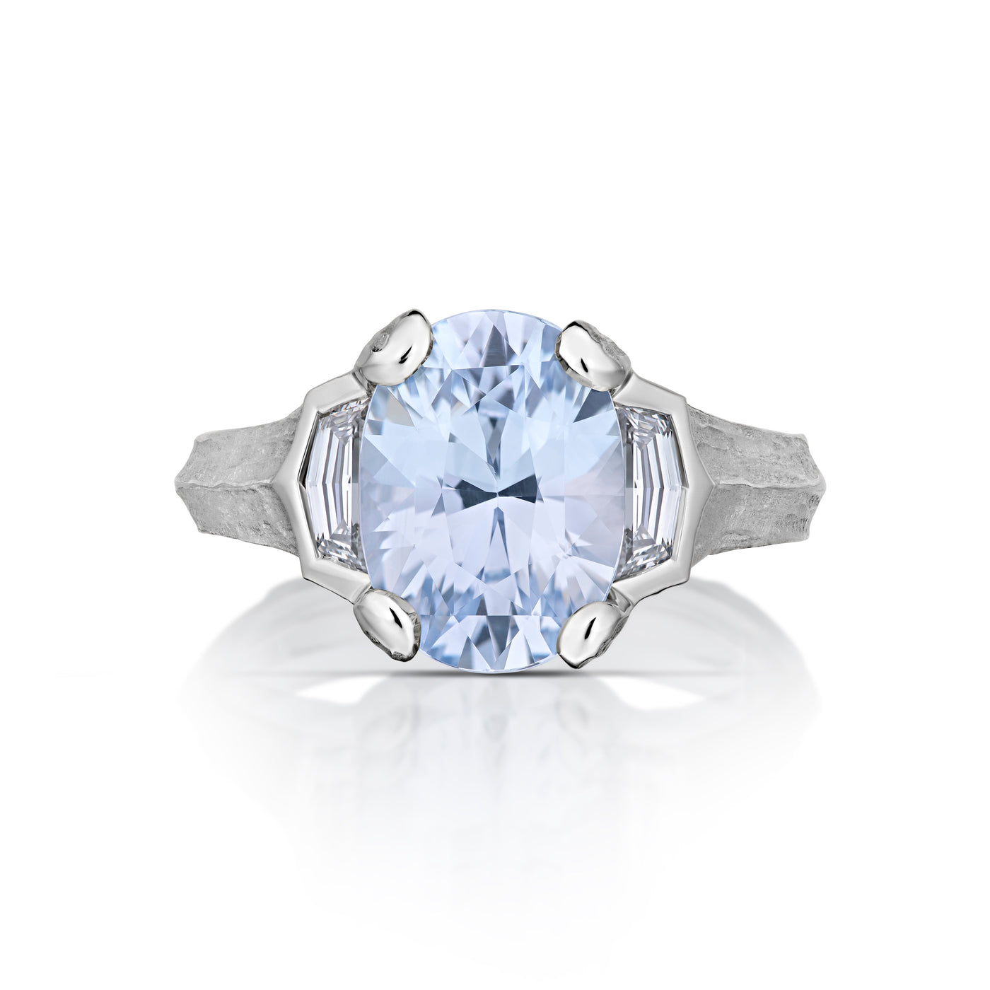 Front view of platinum ring with a large blue gemstone on a white background