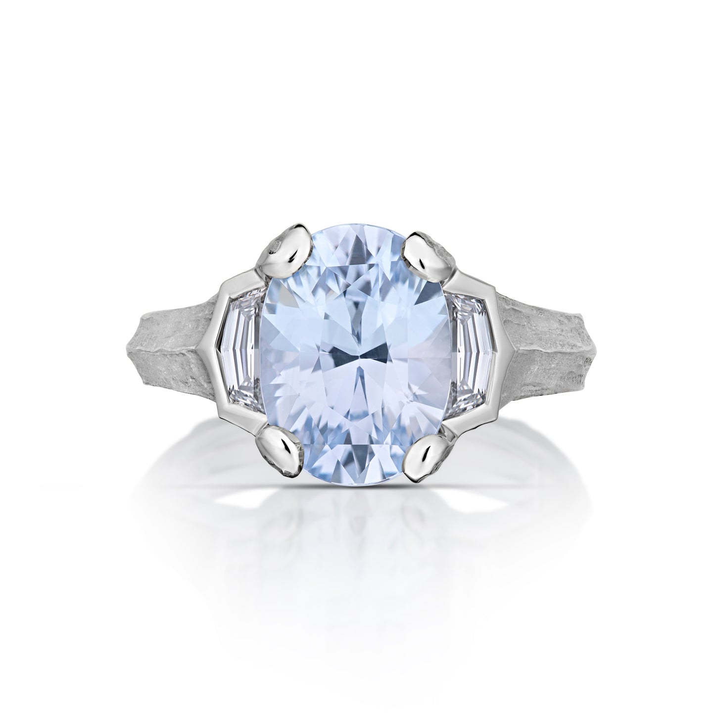 Front view of platinum ring with a large blue gemstone on a white background