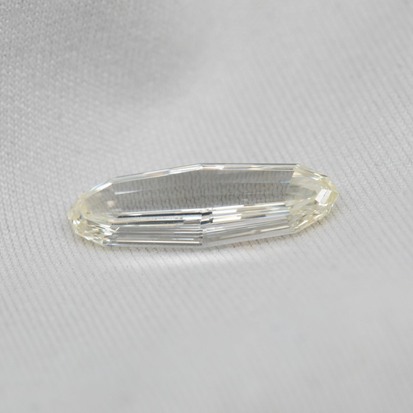 Clear diamond on a white fabric background