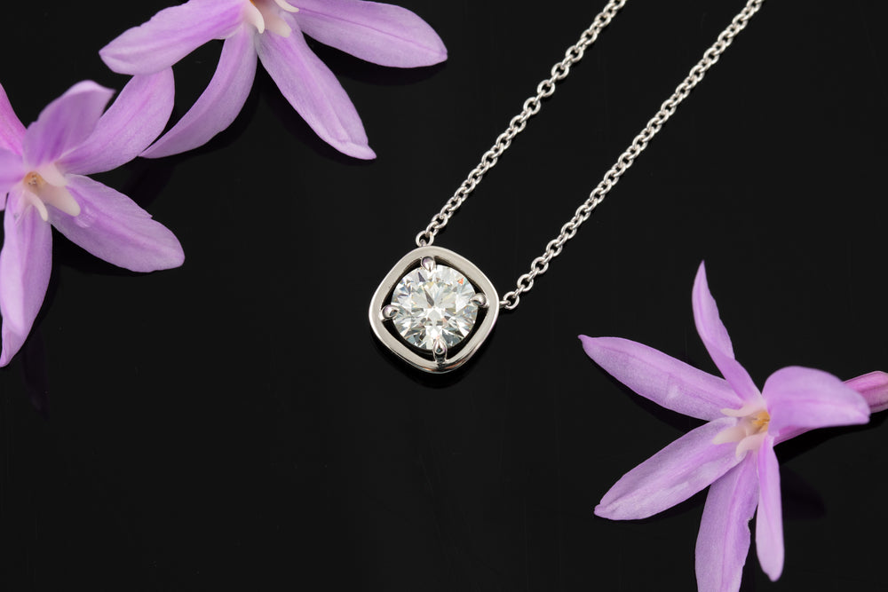 Diamond necklace on a black background with purple flowers