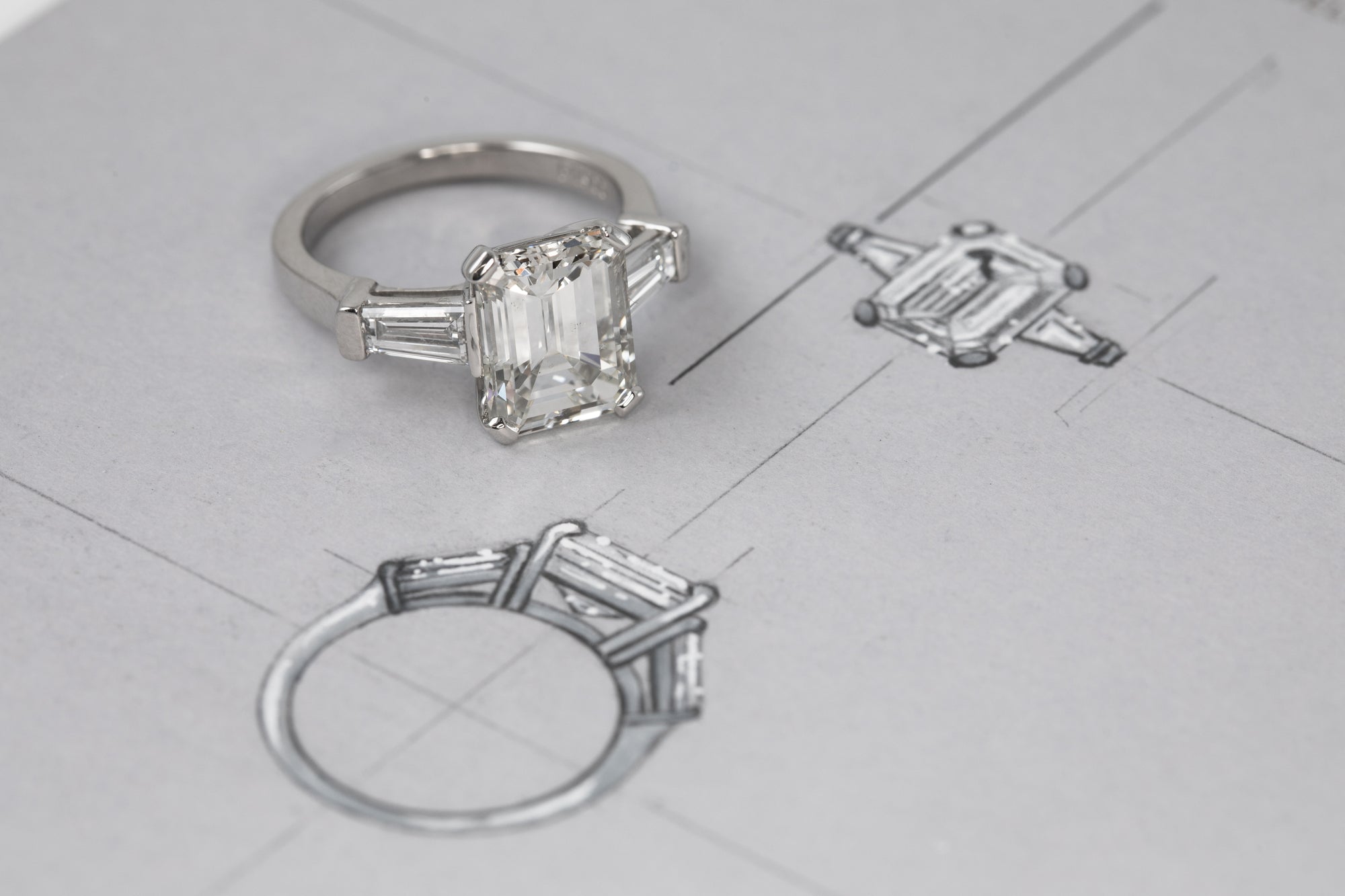 Diamond ring on top of the sketch of the same ring