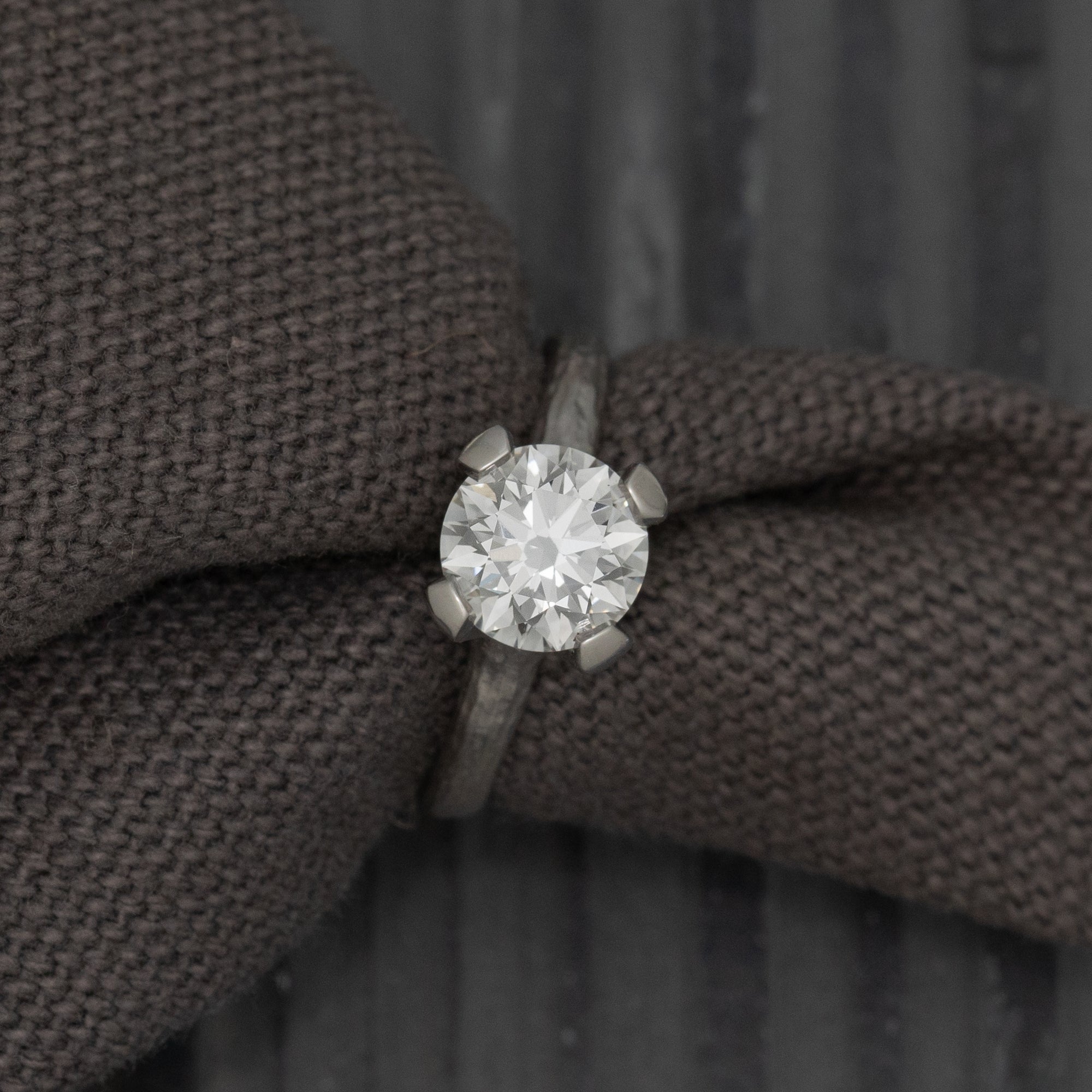 Diamond ring on a textured brown fabric background