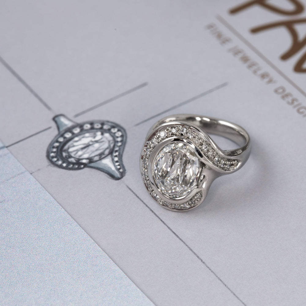 White metal ring with diamonds photographed on gray sketch background. 