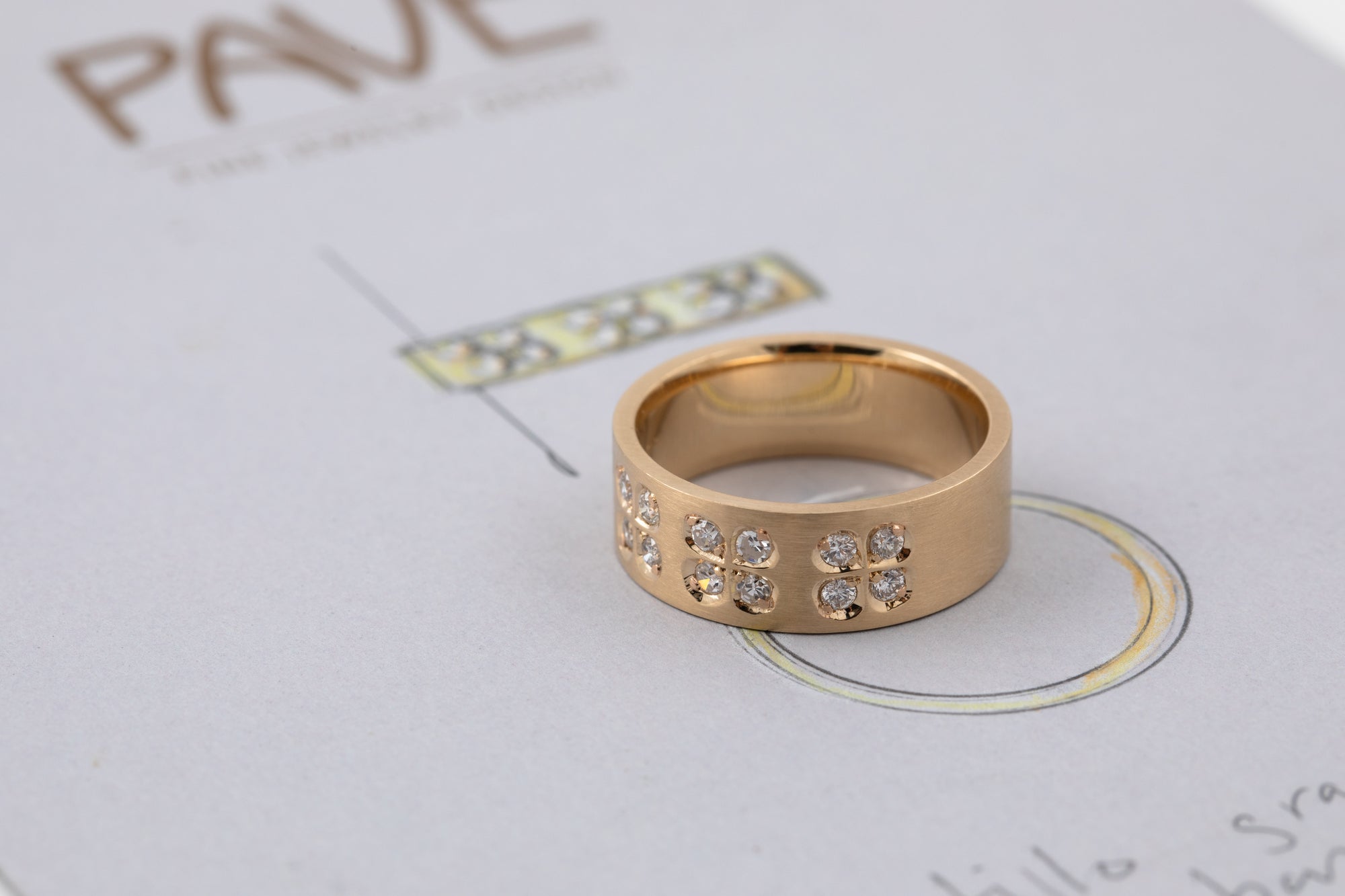 Gold ring with embedded stones on a light background