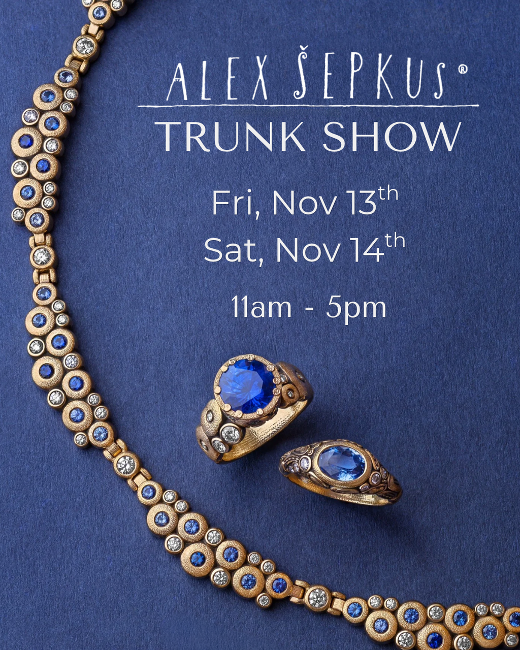 Five colorful rings with varied designs, large vibrant pendants on textured bands. Each ring is placed on blue fabric and photographed on the same blue material. Right hand side text reads: ALEX SEPKUS, NEW YORK. TRUNK SHOW, NOVEMBER 13 & 14 11 AM - 5 PM