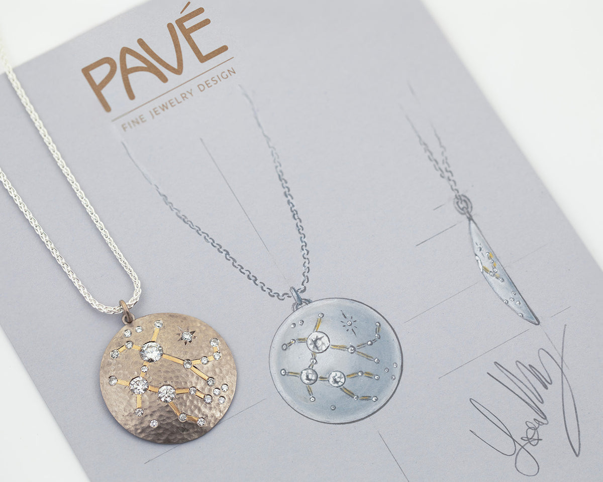 White metal chain with constellation pendant with diamonds photographed on gray sketch background. 