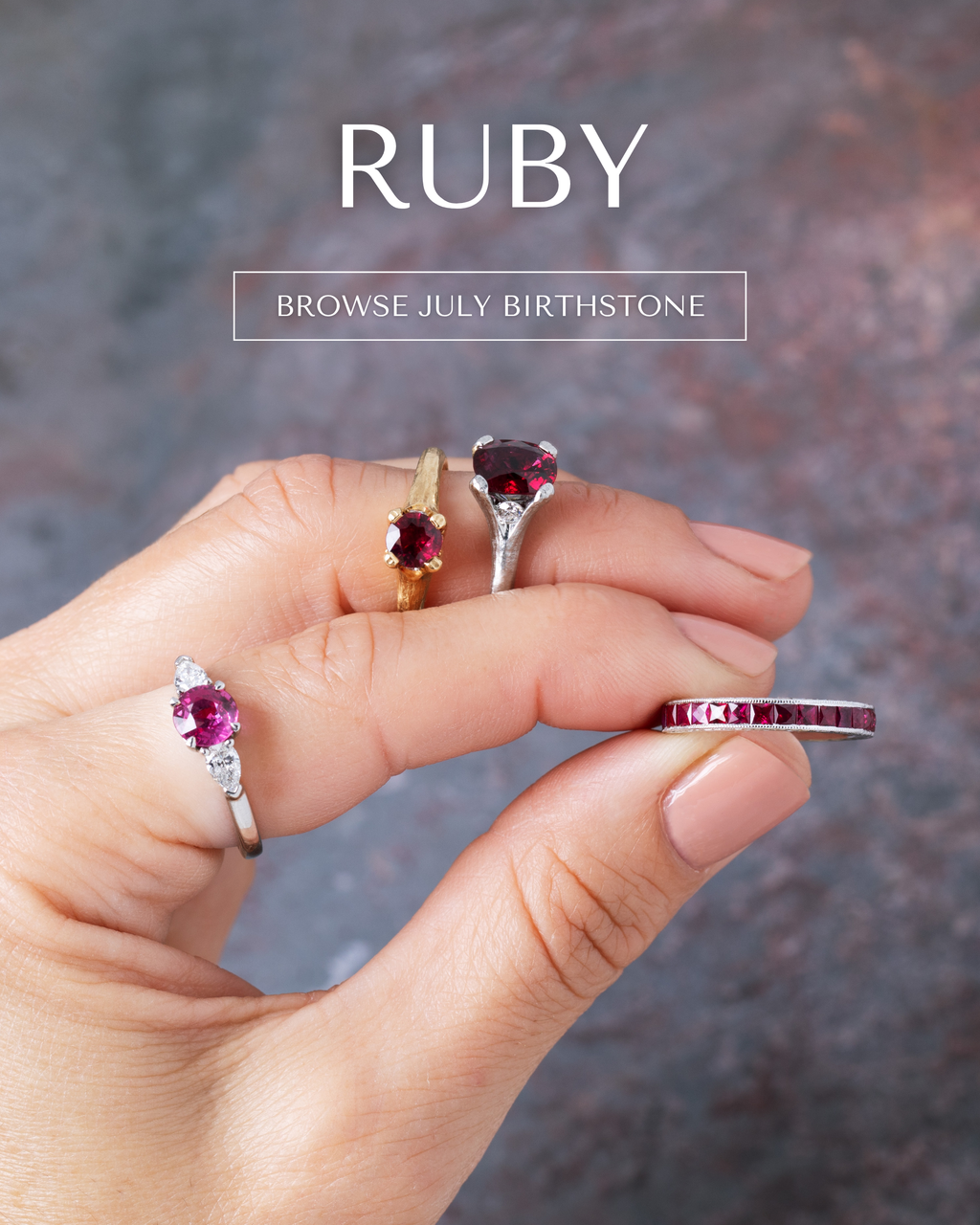 Image: Four rings with rubies displayed on a hand with a grey and red slate background. Text: RUBY [BROWSE JULY BIRTHSTONE] button.